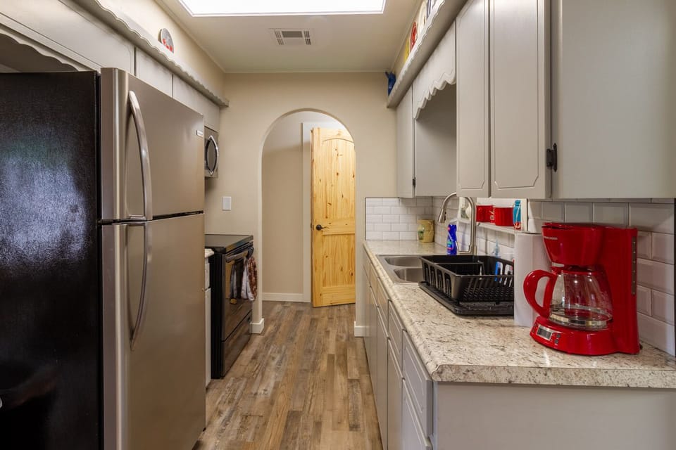 Kitchen with new appliances. Microwave/hood, electric stove, and fridge, w/ice.