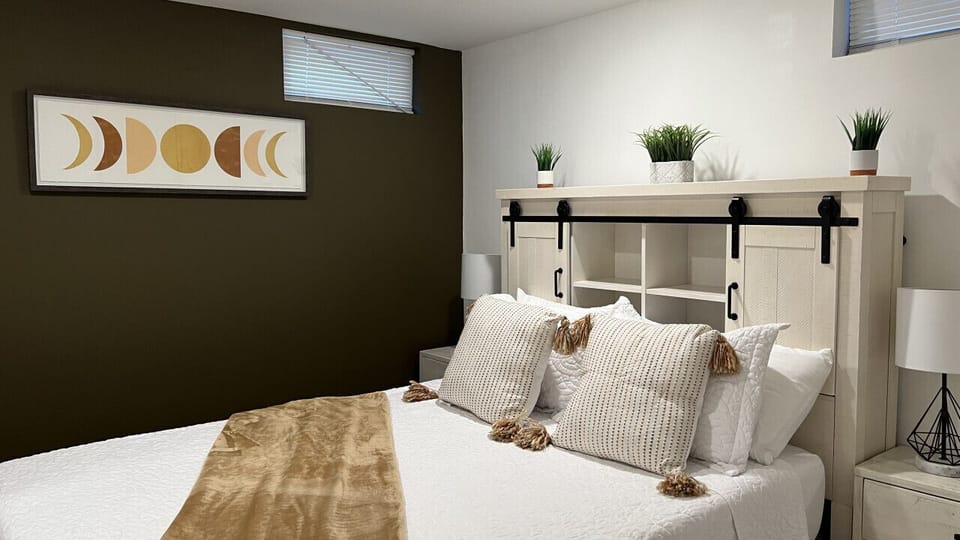 This unique bedroom offer a built in USB headboard for those that enjoy a little phone time before bed. Each bedroom is complete with cotton sheets, pillows, body towels, and makeup towels for each guest. Bedroom 2 offers a peaceful and serene interior. T