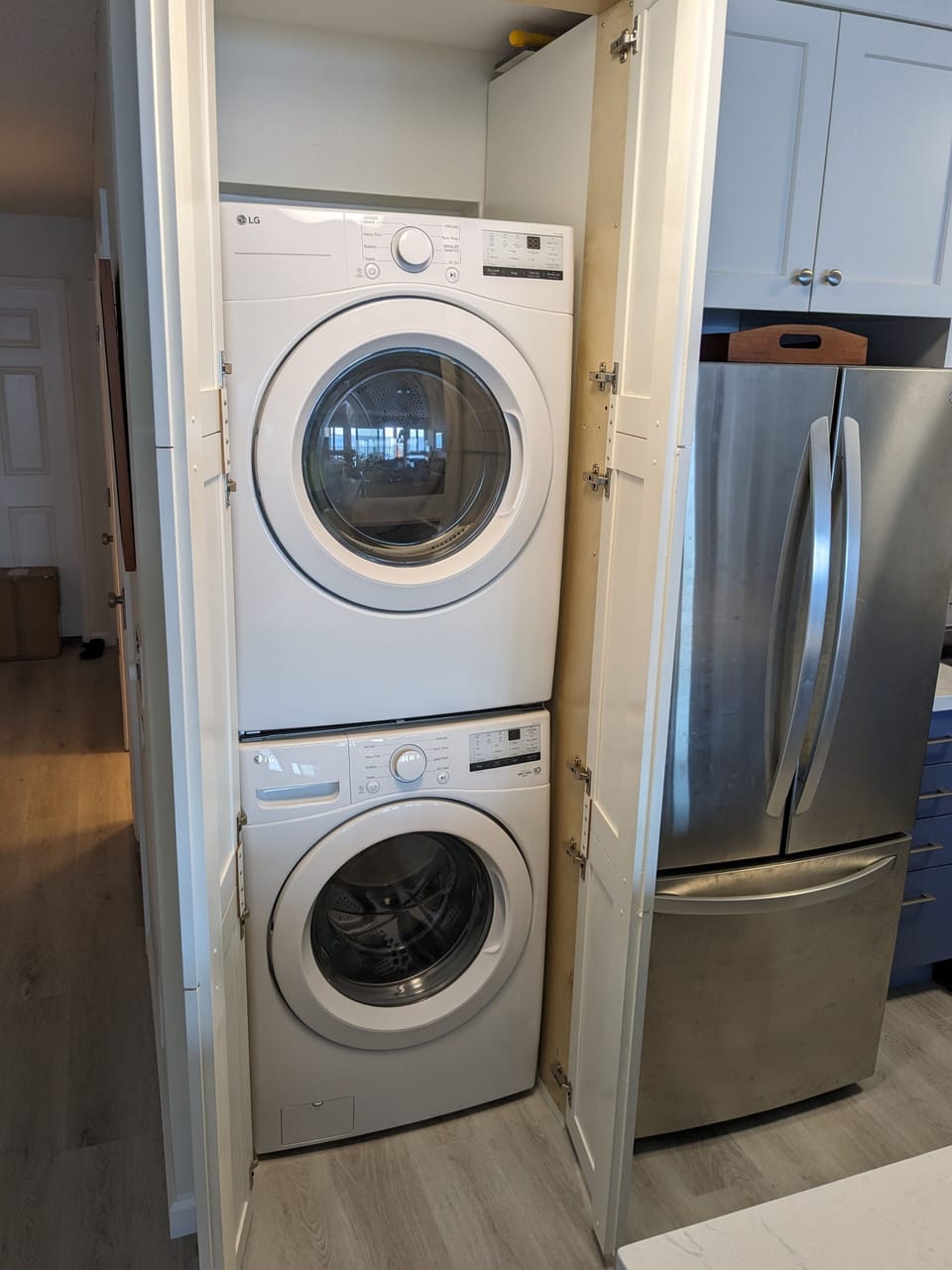 New, full-size washer and dryer in new cabinet