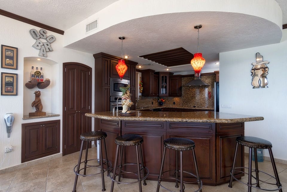The kitchen island with drop lots and elegant dark wood.