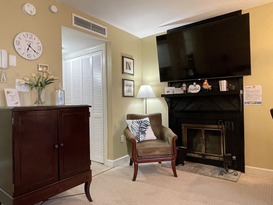 Extra coffee mugs, bowls, & wine glasses located in the cabinet under the clock.