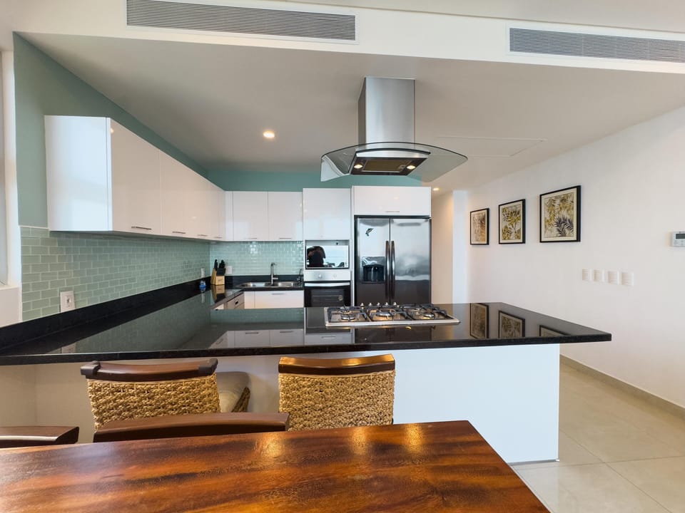 Modern kitchen with sleek countertops and cozy breakfast bar seating
