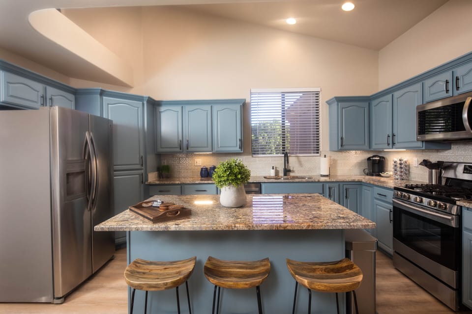 Fully stocked kitchen including cooking basics, keurig, gas stovetop, and island