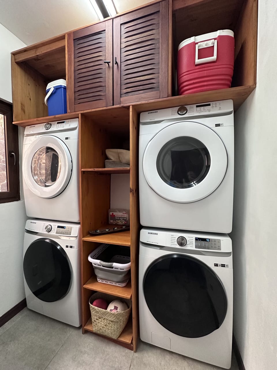 Laundry room with 2 full-size washing machines & 2 full-size dryers.