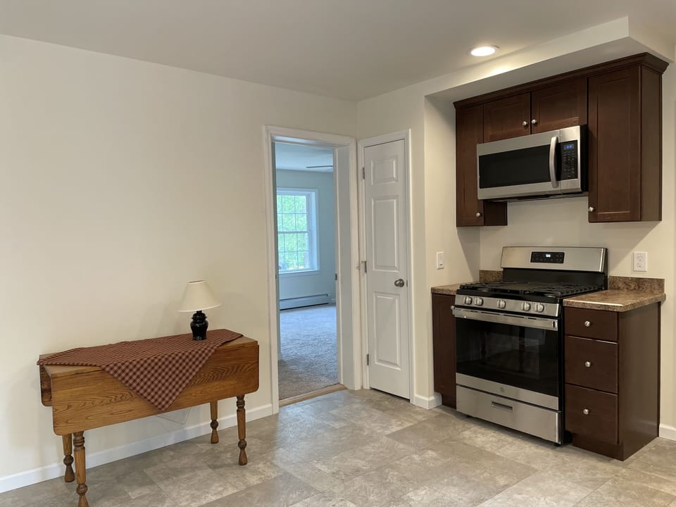 Gas stove& oven w microwave overhead end of Kitchen