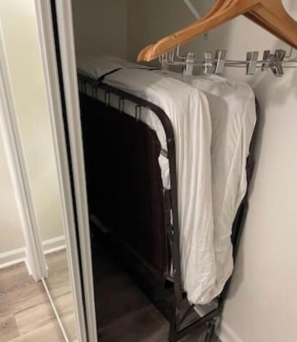 Extra rollaway twin bed stored in the closet of the guest bedroom
