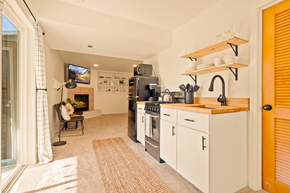 Our kitchen has a fridge, oven, range, sink, microwave, coffee maker, & toaster.