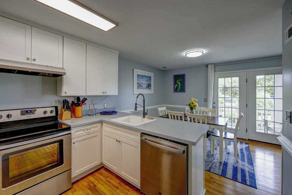 Your bright, fully-equipped kitchen awaits with modern appliances, ample counter space, and charming dining nook perfect for morning coffee.