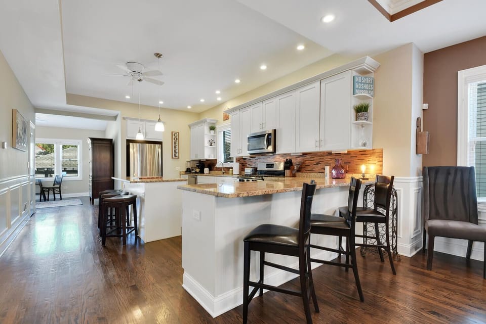Large kitchen with several bar stools