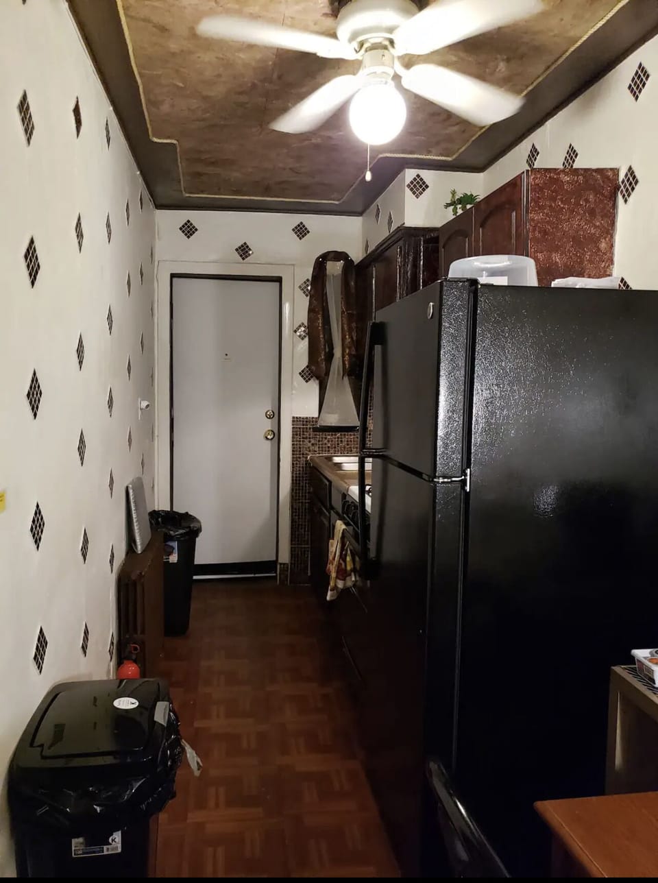 View from hallway, kitchen fridge and dinette