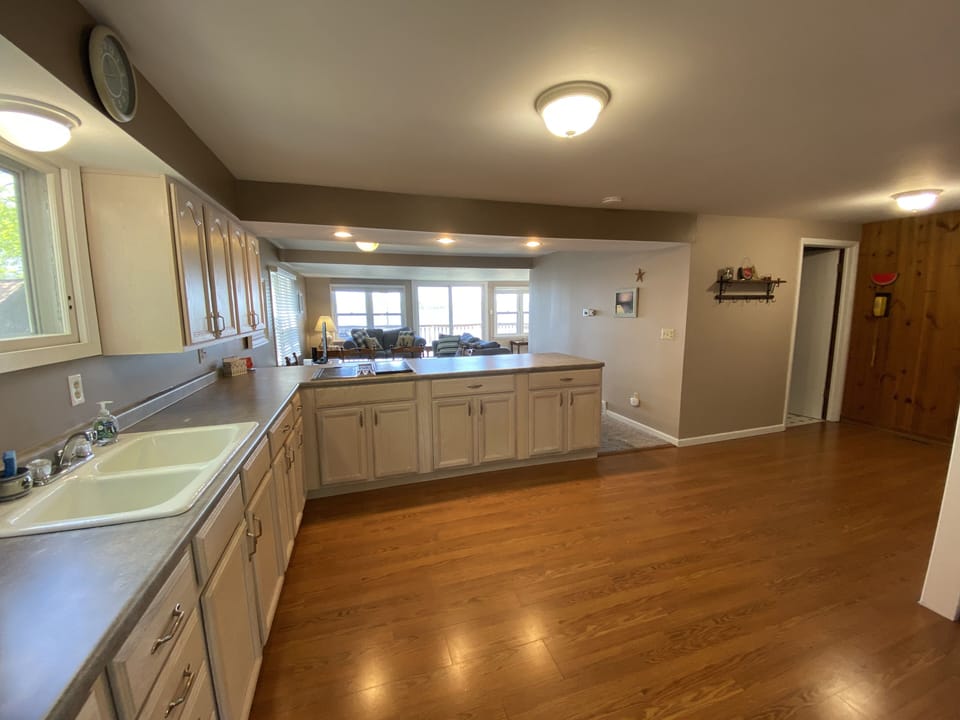 Main level kitchen. Sink, cooktop, refrigerator, microwave.