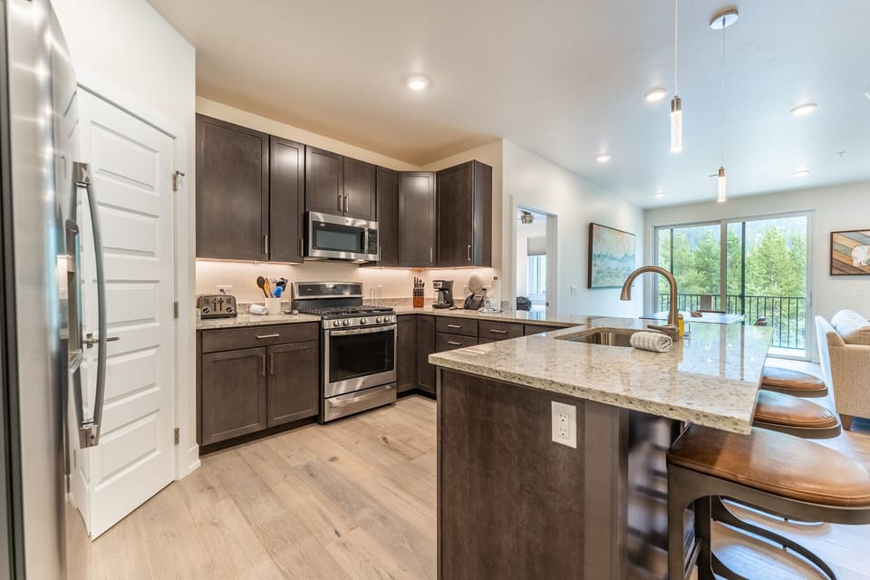 Full size kitchen with high end stainless steel appliances and granite countertops throughout.