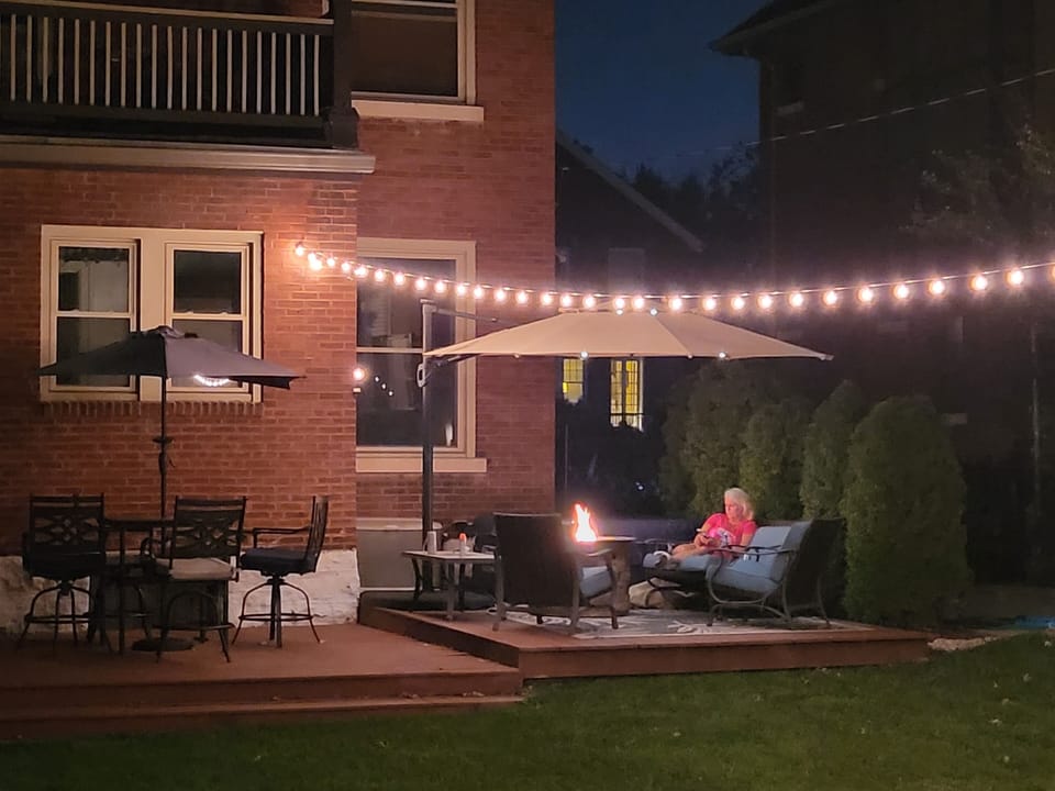 Enjoy sitting around the fire pit with friends and family  under the  lights.