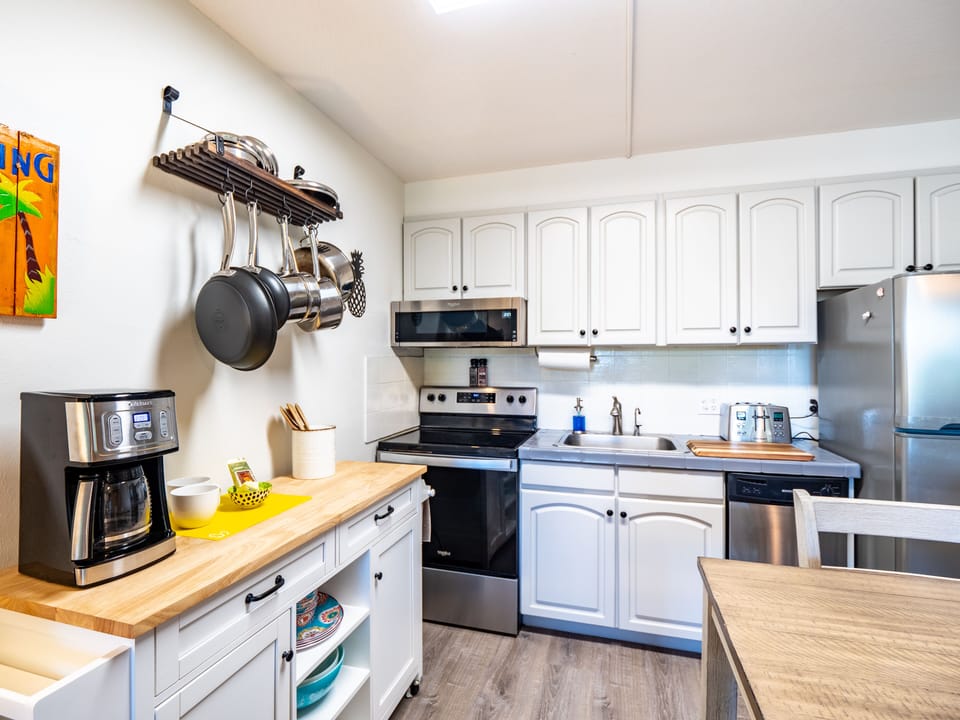 Fully equipped kitchen with quality appliances, pots and pans, and utensils. 
