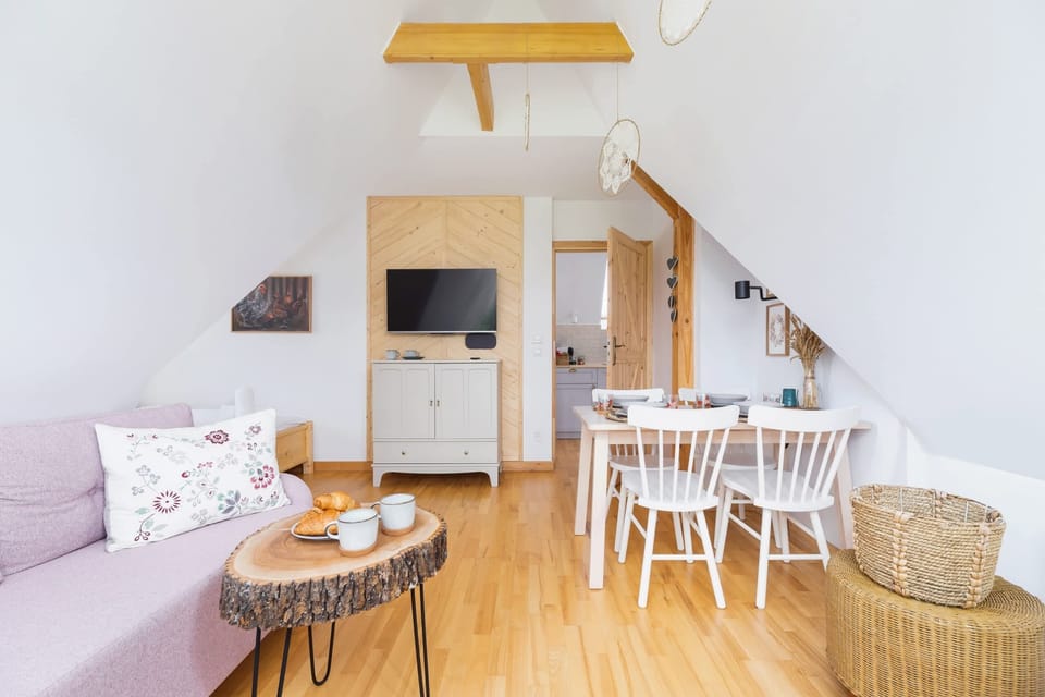  A living room with a wicker table and chair set, ideal for relaxing moments.