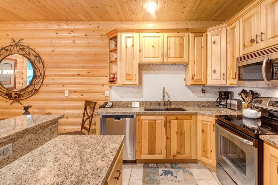 Kitchen island with granite counter, bar seating, and easy access to dining and living areas.
