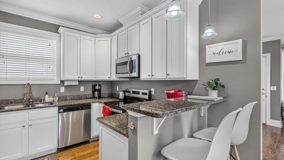 The kitchen has stainless appliances and granite counters