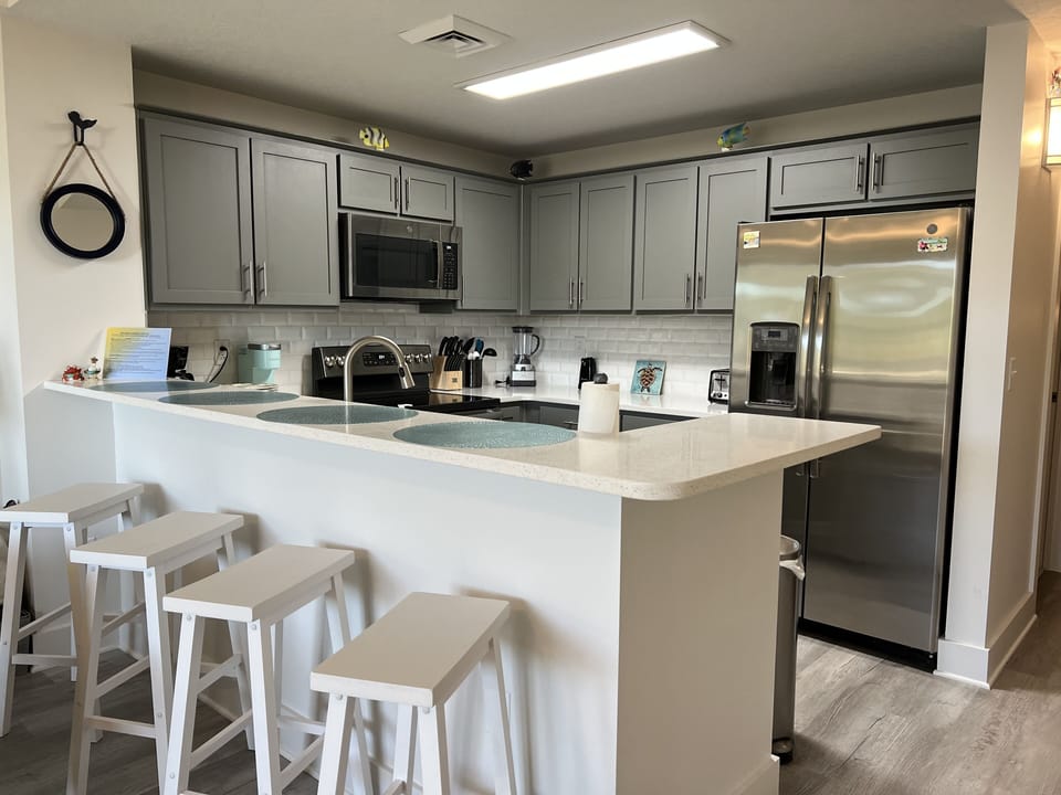 Lots of dining space at the counter, table & chairs, and bar-height balcony set.