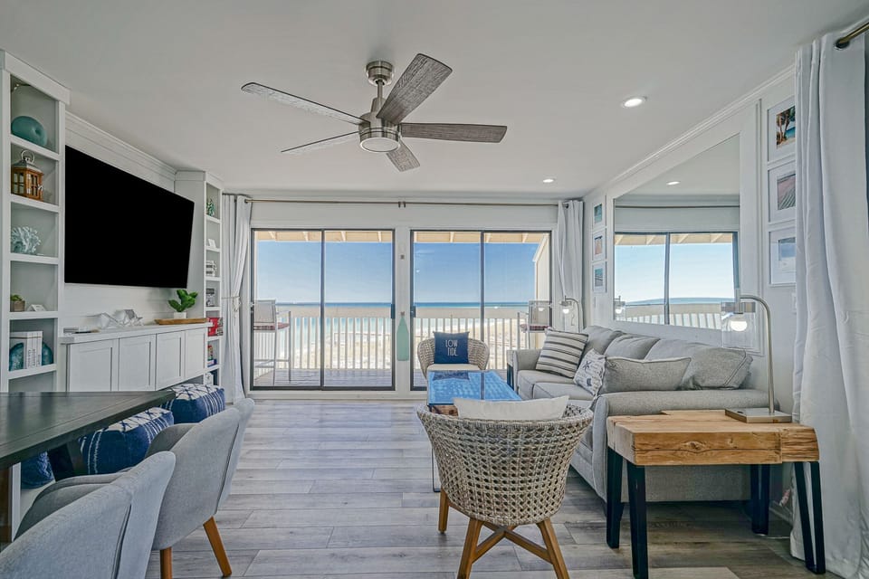 Dining/living room with views of the ocean. Sleeper sofa and black-out curtains.