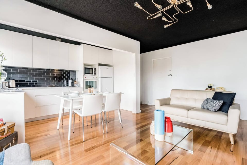 Spacious lounge with a comfortable sofa, seamlessly connected to a fully equipped kitchen — ideal for relaxing and dining in style.