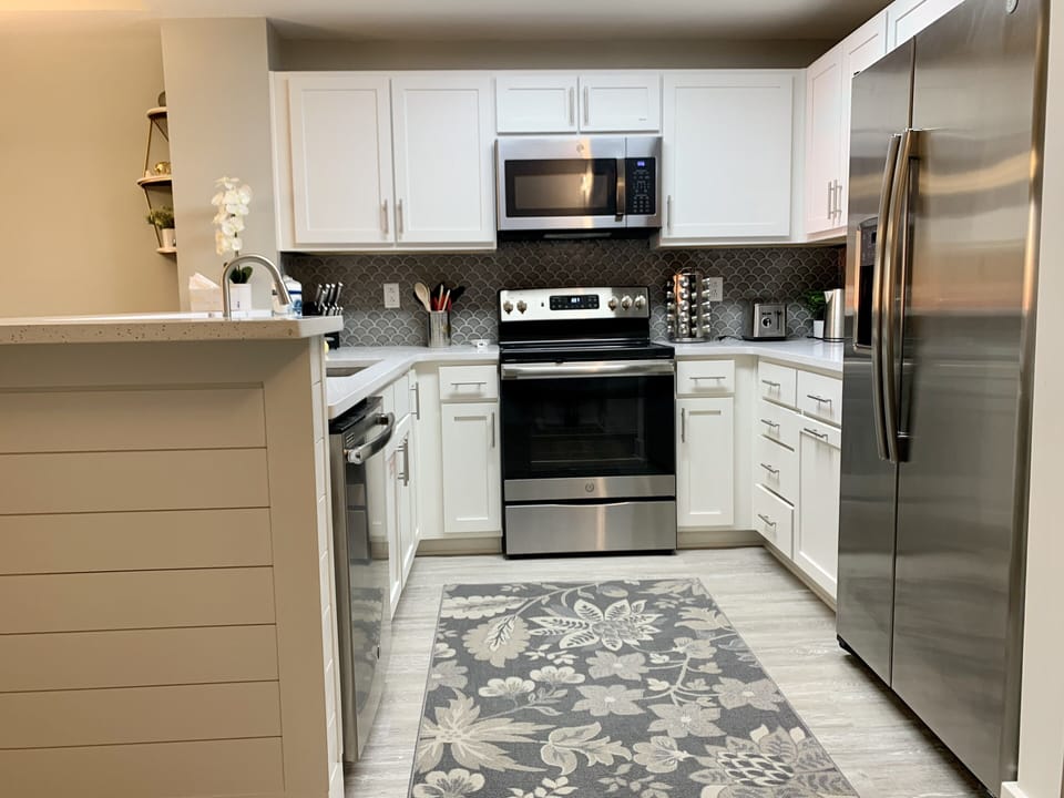 Beautiful kitchen with large sink and stainless steel appliances.