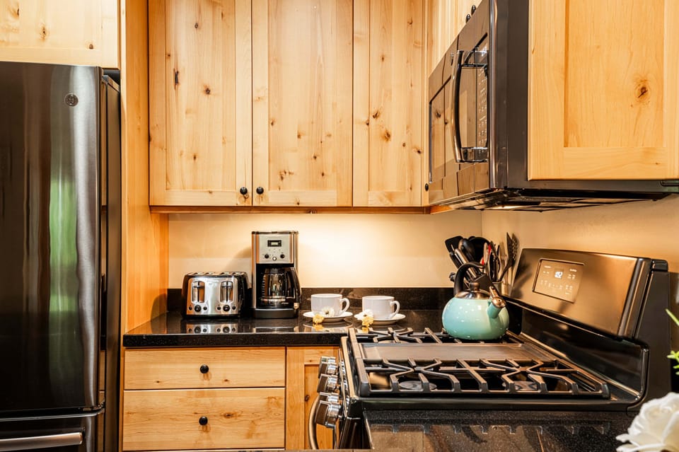 Fully equipped kitchen with black stainless steel appliances