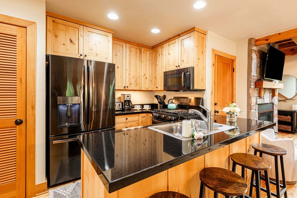 Fully equipped kitchen with black stainless steel appliances