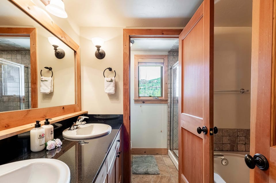 Master bathroom with two sinks, a jetted tub and separate shower