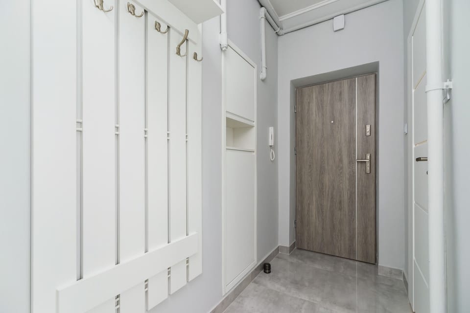 Bright hallway with wooden white coat rack.