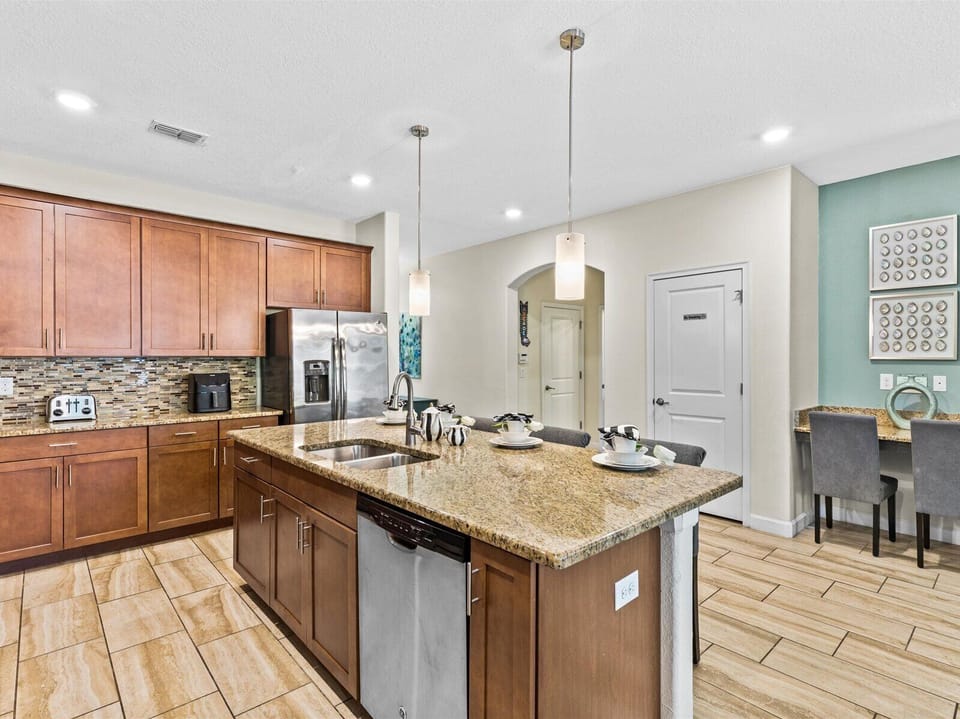 Kitchen island with desk/workspace in background