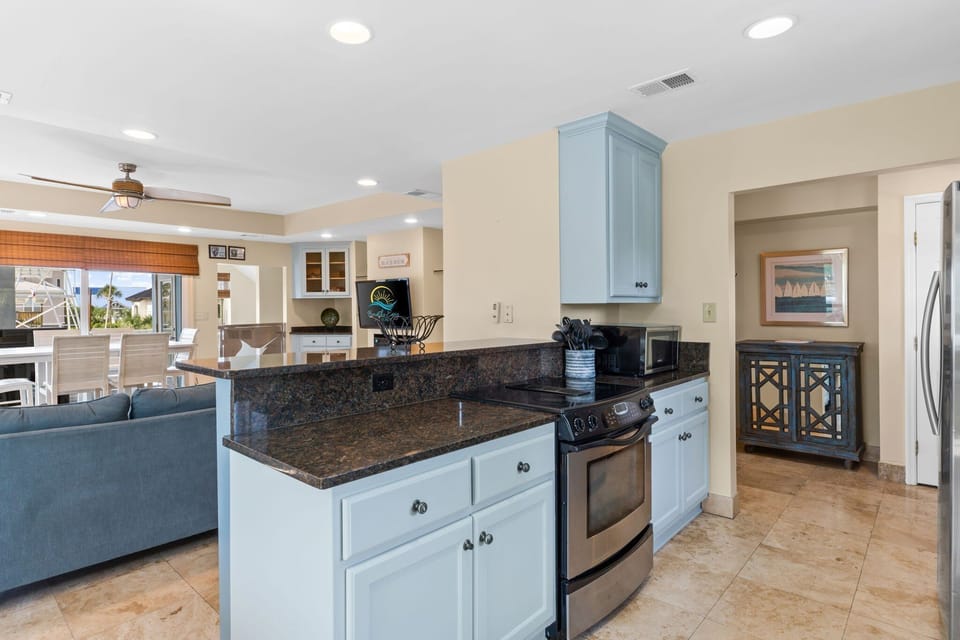 Start your day with coffee at the cozy breakfast nook or gather around the bar stools for casual dining, all while soaking in peaceful views of the sparking canal.

Professionally Managed By 
Breathe Easy Rentals
