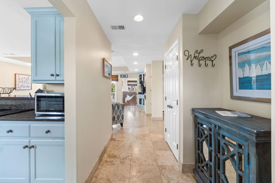 Step into Captain Jax through a bright, inviting entryway featuring coastal decor, natural light, and warm tones that set the stage for your beachside retreat.
Professionall Managed by
Breathe Easy Rentals