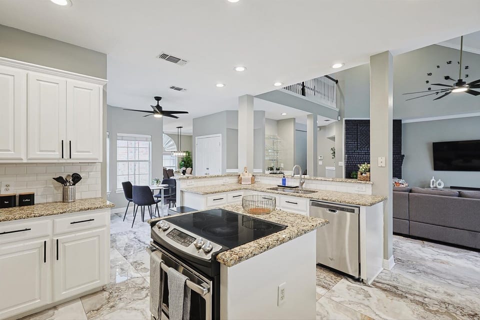 Bright Open-Concept Kitchen with Ample Storage & Stainless Steel Fridge