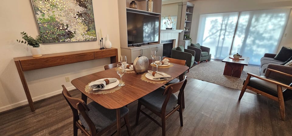 Open concept dining & living room includes TV with Direct TV and streaming apps.