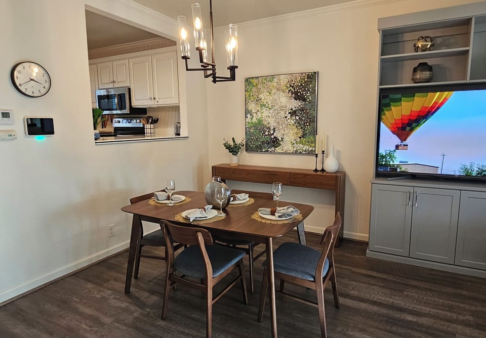 Open concept dining & living room includes TV with Direct TV and streaming apps.
