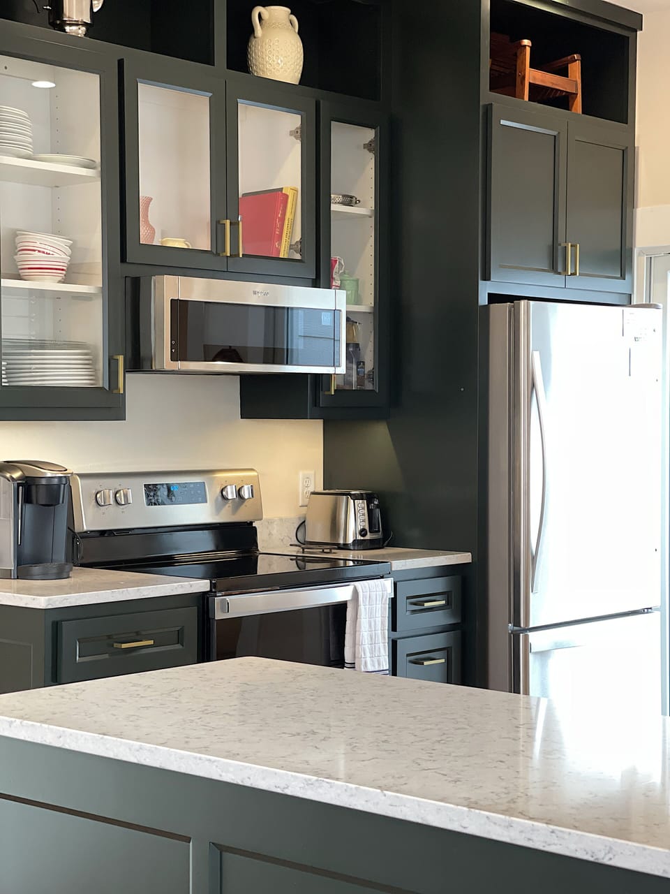 The kitchen opens to the side patio with gas grill
