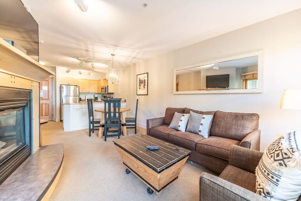 Relax in this open-concept space where your cozy living area flows seamlessly into the fully equipped kitchen, perfect for unwinding after mountain adventures.