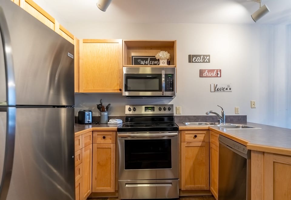 Your fully equipped kitchen makes meal prep a breeze with stainless steel appliances and warm wood cabinetry.