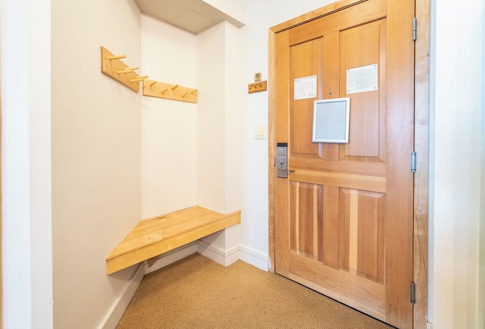 Your private entrance welcomes you with warm wood touches and a convenient bench to settle in after your travels.