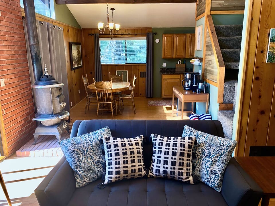 Comfortable Couches, and to the right are the stairs to the loft area with an extra bed.