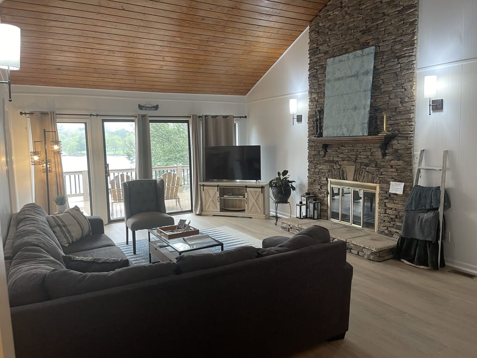 Cozy living room with gas log fireplace!  Great lake view and walk out to deck!