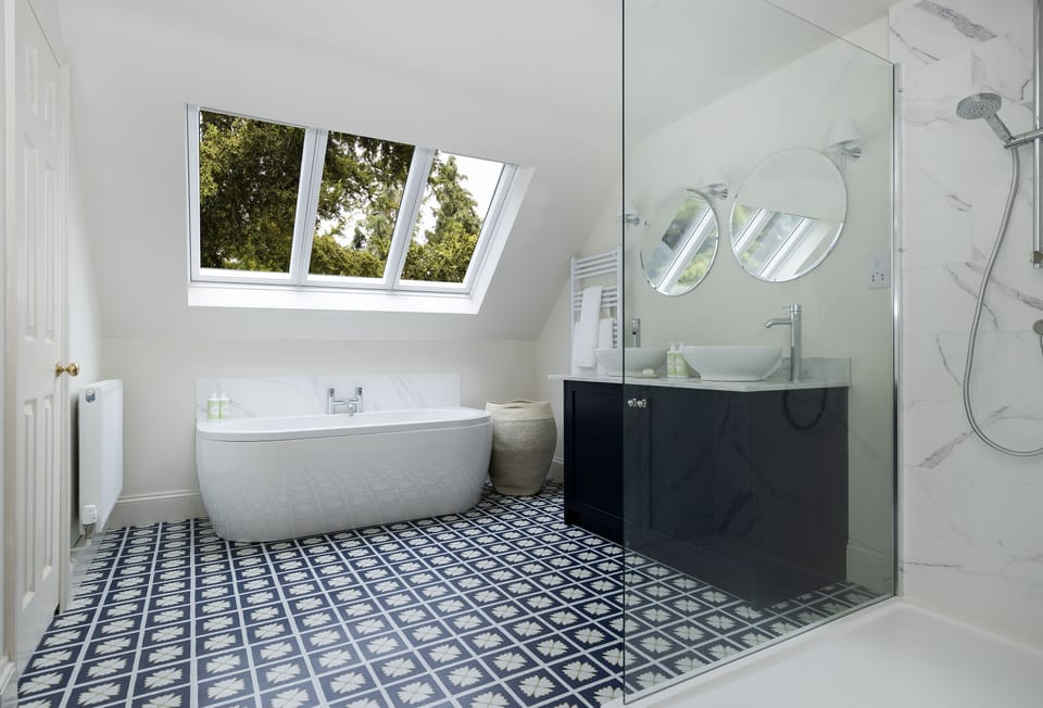 First floor: En-suite bathroom to the master bedroom with separate walk-in shower