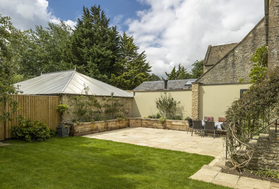 South facing rear walled garden with large terrace and garden furniture