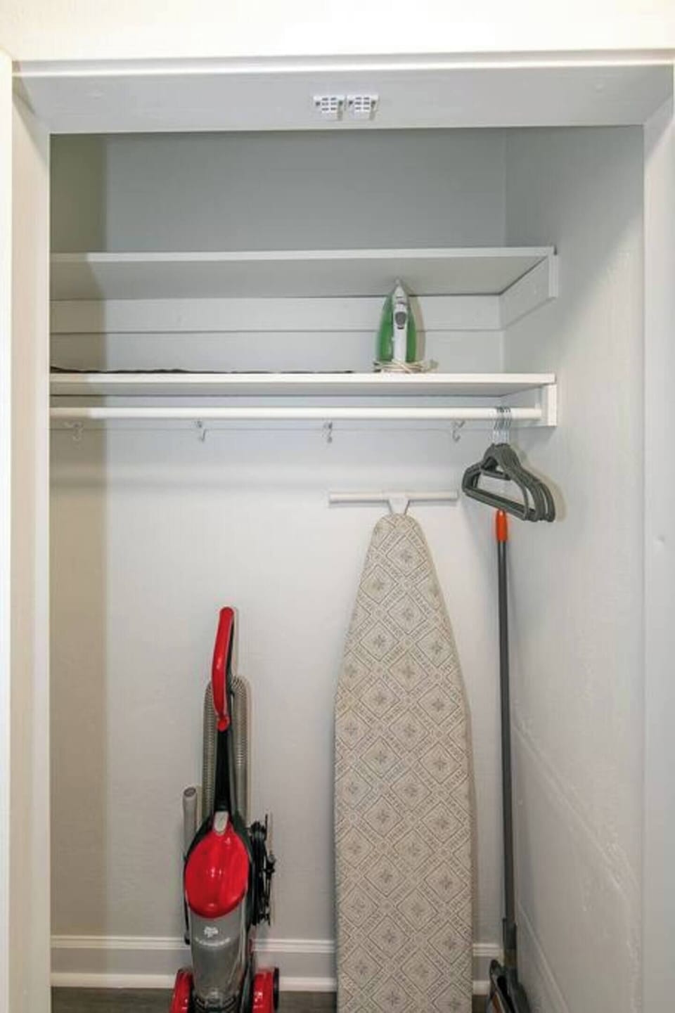 Utility closet w/ hanging rod & space for cleaning essentials