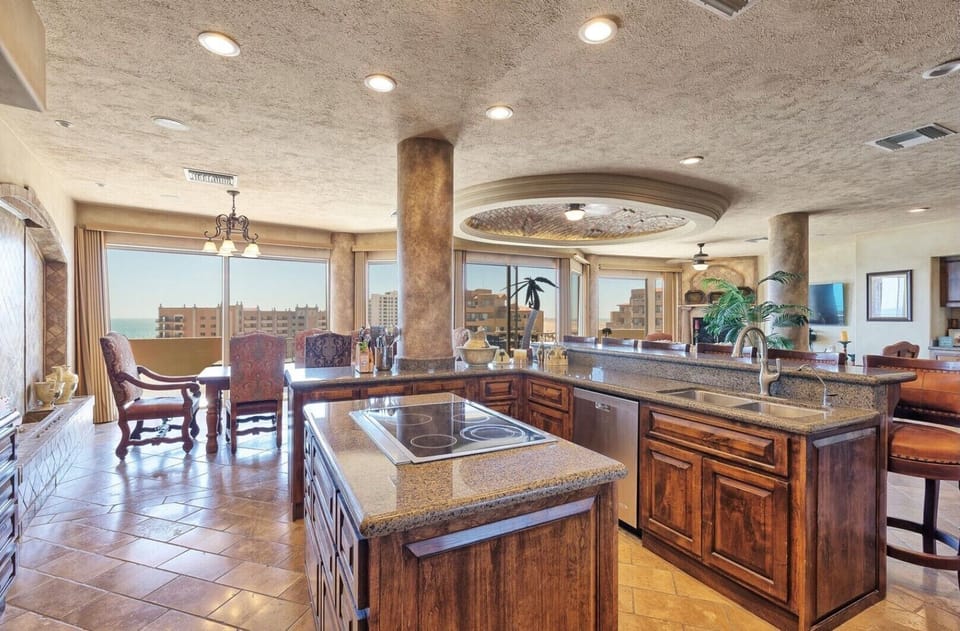 Kitchen with island, complete with all of the necessities.
