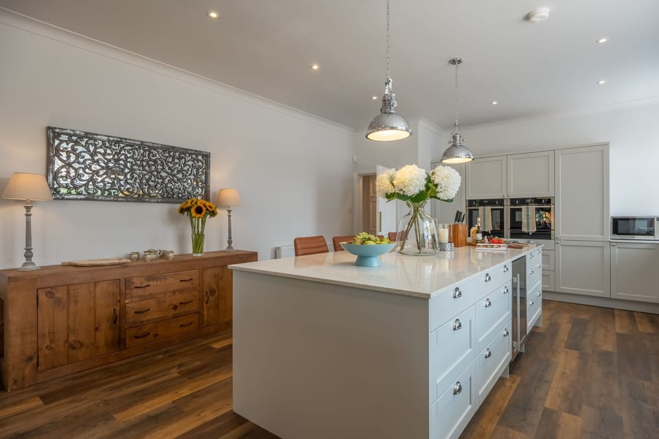Ground floor: Stunning kitchen featuring central island with seating for four