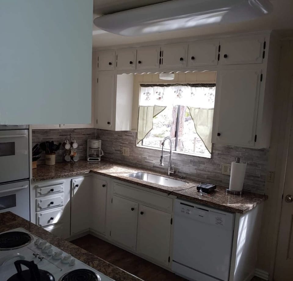 Kitchen features double ovens, cook top, new cookware, Keurig and drip coffee. 