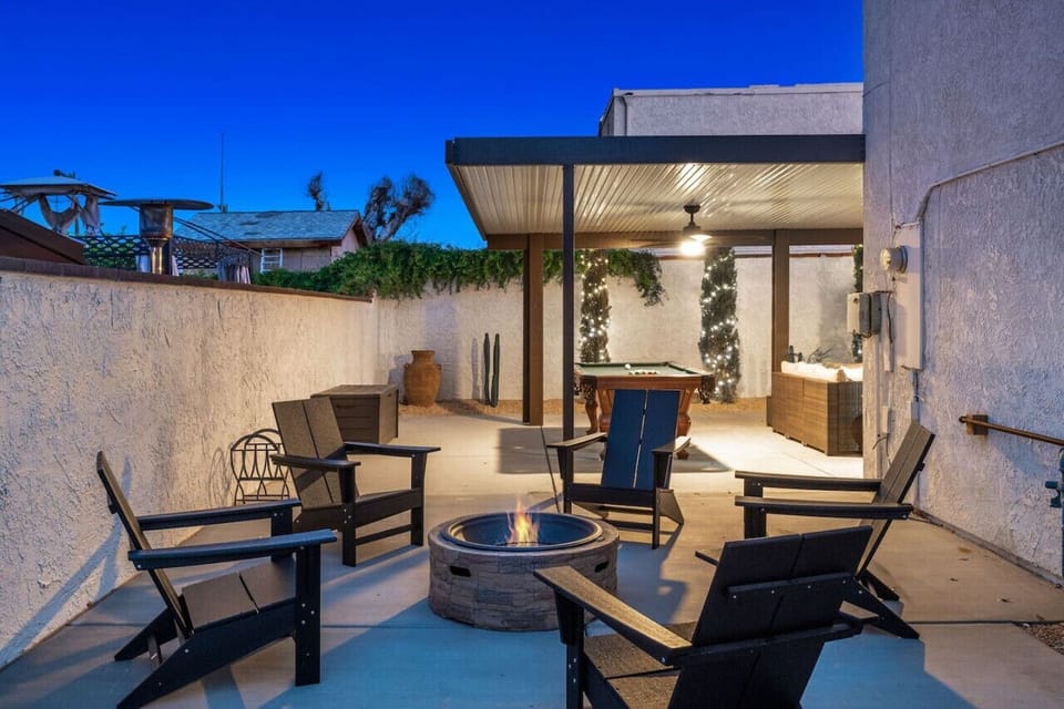 Backyard space: pool/spa, lounge chairs, covered patio, seating area with smart tv, dining table, propane grill, billiards, wood fire pit