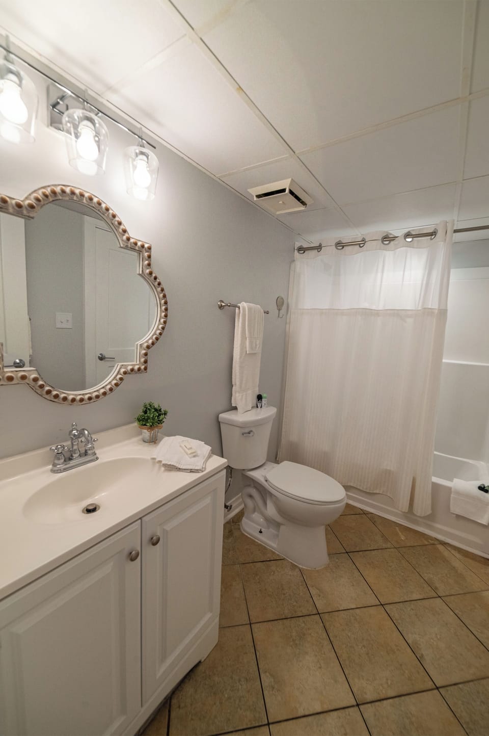Beautiful spa like second bathroom with a tub-shower combo and a single vanity.