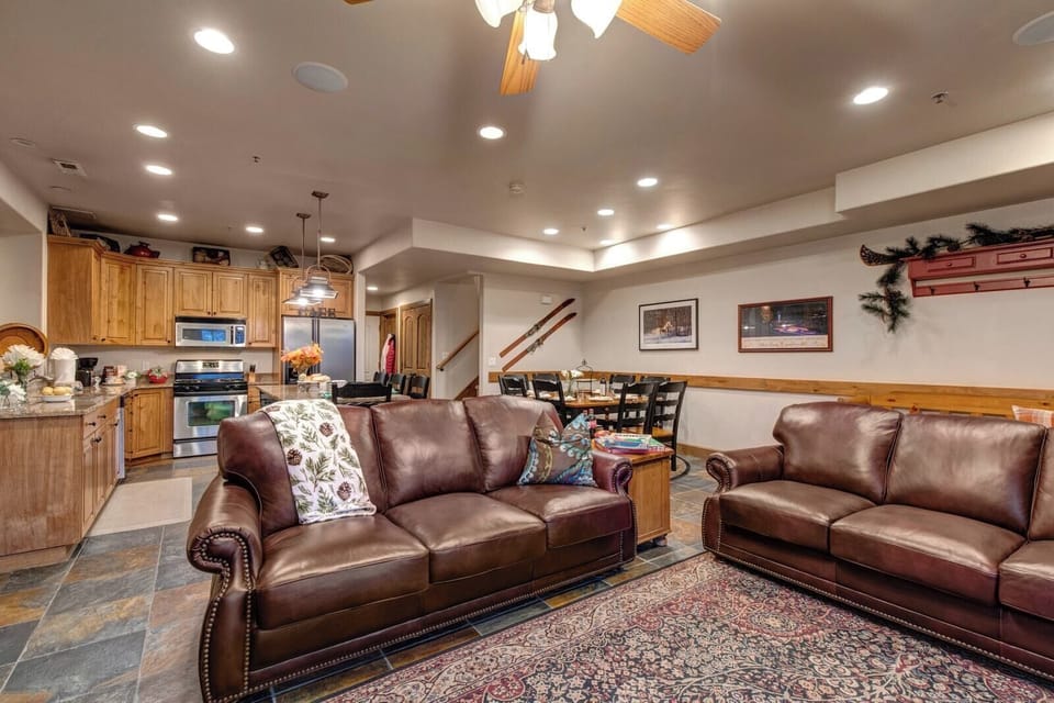 An alternate angle shows cozy seating, high ceilings, and warm wood accents throughout.